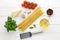 Culinary background with ingredients for recipe of italian pasta bucatini on white wooden background.