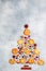 Culinary background of sugar cookies, almonds and spices in the form of a Christmas tree. Delicious biscuits, cinnamon cardamom,