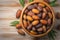 Culinary elegance Dates in a bowl on wooden backdrop