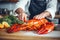 Culinary maestro: chef prepares delectable lobster in restaurant kitchen