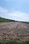 A cultivated field and many tractor tire tracks