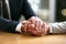 Cultivating a work ethic of compassion. a businessman and businesswoman compassionately holding hands at a table.