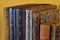 Cultural heritage Row of old bound books. Antique books on yellow background. Close up