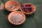 cumin seeds in pottery bowl with dried chilli and spice on banana leaves background