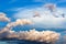 cumuli clouds in dark blue sky in summer evening