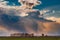 A cumulonimbus storm cloud over the fields and convective rainfall.