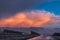 A cumulonimbus storm cloud over the fields and convective rainfall.