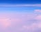 Cumulonimbus and Stratiform Clouds in Infinite Blue Sky with Shades of Pink - Aerial View - Abstract Natural Background