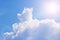 Cumulus and cirrus clouds and bright sunbeams against the blue sky. Atmospheric phenomenon, weather, summer