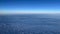 Cumulus clouds against a bright blue horizon. Airplane view