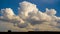 Cumulus clouds in blue sky over house roof