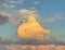 Cumulus clouds form a large gnome head