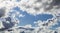 Cumulus Clouds And Grey Storm Clouds Gathering On Blue Sky