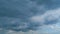 Cumulus clouds moves in the blue sky. Dark huge cloud in sky. Change of weather. Time lapse.