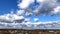 Cumulus clouds over the city timelapse in winter sunny day