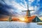 Cumulus clouds on sunset over dutch windmills in Rotterdam. Neth