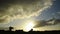 Cumulus clouds in sunset running fast over the countryside in timelapse. Silhouettes of houses, farms, trees in France - Europe. M