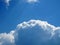 Cumulus curly white clouds on sunny blue sky. nature, climate weather