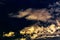 Cumulus and plume yellow tinted clouds against the evening blue sunset sky