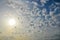 Cumulus sunset clouds with sun setting down