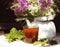 cuo black tea green leaf berry white kettle table sunlight close-up summer outdoor bouquet flowers