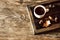 Cup of acorn coffee, acorns and autumn oak leaves on a wooden background