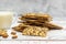 Cup of almond milk and stack of whole grain biscuits on light background. With copy space