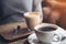 A cup of Americano coffee and a glass of latte coffee on vintage wooden table in cafe