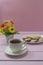 Cup of Americano coffee and homemade pastries on pink background. Coffee time, romance
