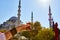 A cup armud of traditional Turkish tea in hand against the background of a mosque in Istanbul