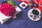 A cup of aromatic coffee, an open book and a branch of hydrangea on a blue background