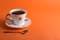 Cup of aromatic coffee on an orange trendy background with space for text