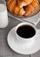 Cup of black coffee and croissant and milk