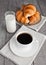 Cup of black coffee and croissant and milk