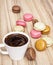 Cup of black coffee with french colorful macarons, food and drink