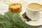 A cup of black coffee and ginger biscuits with spruce twigs on a wooden background, hearty and healthy breakfast