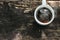 Cup of black coffee with light steam on wooden background