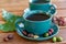 Cup with black coffee served outside with raw green, mature red and roasted coffee beans, decorated with green leaves from coffee