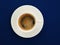 A cup of black coffee on a trendy blue background, top view. Espresso or americano. Cafe and bar, barista art concept. Minimalism