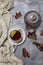 Cup with black tea and lemon and saucer, maple leaves and knitted scarf near, an gray background