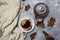 Cup with black tea and lemon and saucer, maple leaves and knitted scarf near, an gray background