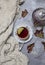 Cup with black tea and lemon and saucer, maple leaves and knitted scarf near, an gray background