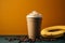 A cup of Blended Banana Coffee on a plain yellow background