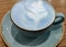 Cup of blue Cappuccino coffee on wooden table
