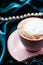 Cup of cappuccino for breakfast with satin and pearls jewellery background, organic coffee with lactose free milk in parisian cafe