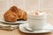 Cup of cappuccino and brioche