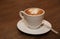 Cup of cappuccino coffee on a brown wooden table. Favorite Morning drink breakfast. With copy space for text.