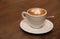 Cup of cappuccino coffee on a brown wooden table. Favorite Morning drink breakfast. With copy space for text.