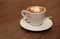 Cup of cappuccino coffee on a brown wooden table. Favorite Morning drink breakfast. With copy space for text.