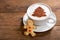 Cup of cappuccino coffee with christmas tree drawing and gingerbread cookie